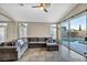 Cozy living room with a large sectional, leading to a refreshing outdoor pool view at 8406 Belmont Valley St, Las Vegas, NV 89123