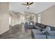 Spacious living room with tile flooring, gray sectional sofa, and neutral color palette at 8406 Belmont Valley St, Las Vegas, NV 89123