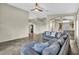 Bright living room with tile floors, ceiling fan, and a large gray sectional sofa at 8406 Belmont Valley St, Las Vegas, NV 89123