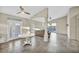 Open-concept living area featuring tiled floors, a ceiling fan, and sliding glass doors leading to the backyard at 8406 Belmont Valley St, Las Vegas, NV 89123