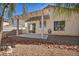 Backyard patio area with rock landscaping and desert trees at 8732 Majestic Pine Ave, Las Vegas, NV 89143