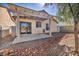 Back patio area with pergola cover and desert landscaping features at 8732 Majestic Pine Ave, Las Vegas, NV 89143