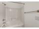 Bright bathroom with a clean white tub and shower featuring white tile at 8732 Majestic Pine Ave, Las Vegas, NV 89143
