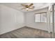 Cozy bedroom with ceiling fan, window with wood blinds, and mirrored closet at 8732 Majestic Pine Ave, Las Vegas, NV 89143