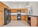 Updated kitchen with wood cabinets and black appliances offers plenty of counter space at 8732 Majestic Pine Ave, Las Vegas, NV 89143