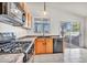View of the kitchen featuring a stainless steel stove, modern fixtures, and granite countertops at 8732 Majestic Pine Ave, Las Vegas, NV 89143