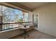 Cozy balcony with a small table and views of palm trees and the surrounding neighborhood at 908 Domnus Ln # 203, Las Vegas, NV 89144