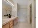 Bright bathroom features dual sinks, a large mirror, and a shower-tub combo with sliding glass doors at 908 Domnus Ln # 203, Las Vegas, NV 89144