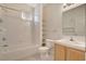 Bathroom featuring a tub with shower, shelves, toilet, and sink with wood cabinets at 908 Domnus Ln # 203, Las Vegas, NV 89144