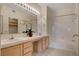 Bright bathroom featuring a double sink vanity with a large mirror and a shower-tub combination at 908 Domnus Ln # 203, Las Vegas, NV 89144