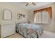 Bright bedroom with wicker furniture, neutral walls, and window at 908 Domnus Ln # 203, Las Vegas, NV 89144