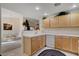 Bright kitchen space showcasing wood cabinets, white countertops, and seamless transition to dining area with natural light at 908 Domnus Ln # 203, Las Vegas, NV 89144