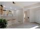 Open-concept kitchen with light wood cabinets, breakfast bar, adjacent to cozy dining and living area at 908 Domnus Ln # 203, Las Vegas, NV 89144