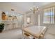 Bright kitchen, adjacent to the dining area, featuring white appliances, natural lighting, and a breakfast bar at 908 Domnus Ln # 203, Las Vegas, NV 89144