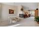 Inviting living room featuring a fireplace, chandelier, access to a balcony, and neutral carpeting at 908 Domnus Ln # 203, Las Vegas, NV 89144