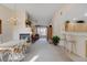 Spacious living area with a fireplace, ceiling fan, breakfast bar, and dining area with natural light at 908 Domnus Ln # 203, Las Vegas, NV 89144