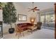 Inviting living room with comfortable leather seating, ceiling fan, and access to the balcony at 908 Domnus Ln # 203, Las Vegas, NV 89144