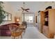 Inviting living room featuring a ceiling fan, plush seating, and sliding glass doors to a private balcony at 908 Domnus Ln # 203, Las Vegas, NV 89144