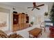 Bright living room features a ceiling fan, comfortable seating, and a decorative entertainment center at 908 Domnus Ln # 203, Las Vegas, NV 89144
