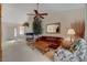 Cozy living room with classic furniture, a ceiling fan, and a view into the dining area and the fireplace at 908 Domnus Ln # 203, Las Vegas, NV 89144