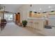 Bright living space and kitchen with bar stool seating with a ceiling fan and sliding door to balcony at 908 Domnus Ln # 203, Las Vegas, NV 89144