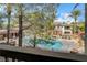Scenic view of the community pool with lounge chairs and shade structures surrounded by lush greenery at 908 Domnus Ln # 203, Las Vegas, NV 89144