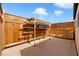 Backyard patio area with wood fence and stored building materials at 91 Hawk Ave, Pahrump, NV 89060