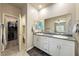 Bathroom featuring double sinks, granite countertops, walk-in closet, and tile flooring at 91 Hawk Ave, Pahrump, NV 89060