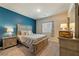 Neutral bedroom featuring a plush bed, blue accent wall and closet, perfect for relaxation and storage at 91 Hawk Ave, Pahrump, NV 89060