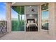 Bedroom entrance onto the exterior patio featuring stone columns and ornamental railing with beautiful mountain views at 9101 Alta Dr # 205, Las Vegas, NV 89145