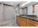 Modern bathroom featuring a spacious walk-in shower with a glass enclosure and dark marble countertops at 9101 Alta Dr # 205, Las Vegas, NV 89145