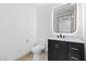 Stylish half-bathroom featuring a modern vanity with gold accents and a sleek, illuminated mirror at 9101 Alta Dr # 205, Las Vegas, NV 89145