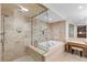 This bathroom features travertine floors and walls, a glass shower, and a soaking tub at 9101 Alta Dr # 205, Las Vegas, NV 89145