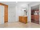 A bathroom featuring travertine floors, a single sink vanity, and access to walk-in closet at 9101 Alta Dr # 205, Las Vegas, NV 89145