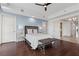 Comfortable bedroom with hardwood floors, ceiling fan, and a doorway leading to the kitchen at 9101 Alta Dr # 205, Las Vegas, NV 89145