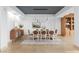 Stylishly staged dining room with modern lighting, complementary furniture, and area rug at 9101 Alta Dr # 205, Las Vegas, NV 89145