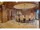 Formal dining room with hardwood paneling, large round table and decorative floor at 9101 Alta Dr # 205, Las Vegas, NV 89145