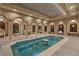 Luxurious indoor pool with stone pillars, archways, and intricate tile work, creating a spa-like retreat at 9101 Alta Dr # 205, Las Vegas, NV 89145