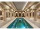 Elegant indoor pool featuring tile flooring, stone columns, and a decorative ceiling, perfect for relaxation at 9101 Alta Dr # 205, Las Vegas, NV 89145