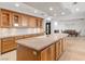 Large kitchen island with granite counters, custom cabinets, and an adjacent dining room at 9101 Alta Dr # 205, Las Vegas, NV 89145