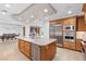 Open kitchen with stainless steel appliances, island with sink, and adjacent dining area at 9101 Alta Dr # 205, Las Vegas, NV 89145