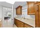 Spacious laundry room with wood cabinetry, ample countertop space, and a view to the bedroom at 9101 Alta Dr # 205, Las Vegas, NV 89145
