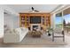 Staged living room featuring built-ins, fireplace, comfortable seating, and access to balcony at 9101 Alta Dr # 205, Las Vegas, NV 89145