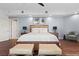 A spacious main bedroom features dark hardwood floors, light blue walls, and modern furnishings at 9101 Alta Dr # 205, Las Vegas, NV 89145