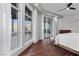 Bright bedroom featuring large windows, access to a balcony, hardwood floors, and white walls at 9101 Alta Dr # 205, Las Vegas, NV 89145