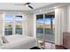 Bright main bedroom featuring wood floors, a ceiling fan, and large windows offering stunning mountain views at 9101 Alta Dr # 205, Las Vegas, NV 89145