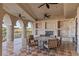 Covered patio with stone accents, wrought iron railing, ceiling fans, and a stone table set at 9101 Alta Dr # 205, Las Vegas, NV 89145