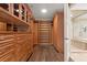 This large walk-in closet features custom shelving, drawers, and hardwood floors at 9101 Alta Dr # 205, Las Vegas, NV 89145