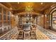Elegant wine cellar featuring wooden cabinetry, a dining table and ornate chandelier at 9101 Alta Dr # 205, Las Vegas, NV 89145