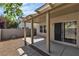 A covered patio with neutral colors, a gravel area, and block wall make this backyard a relaxing outdoor space at 9526 Vast Valley Ave, Las Vegas, NV 89148